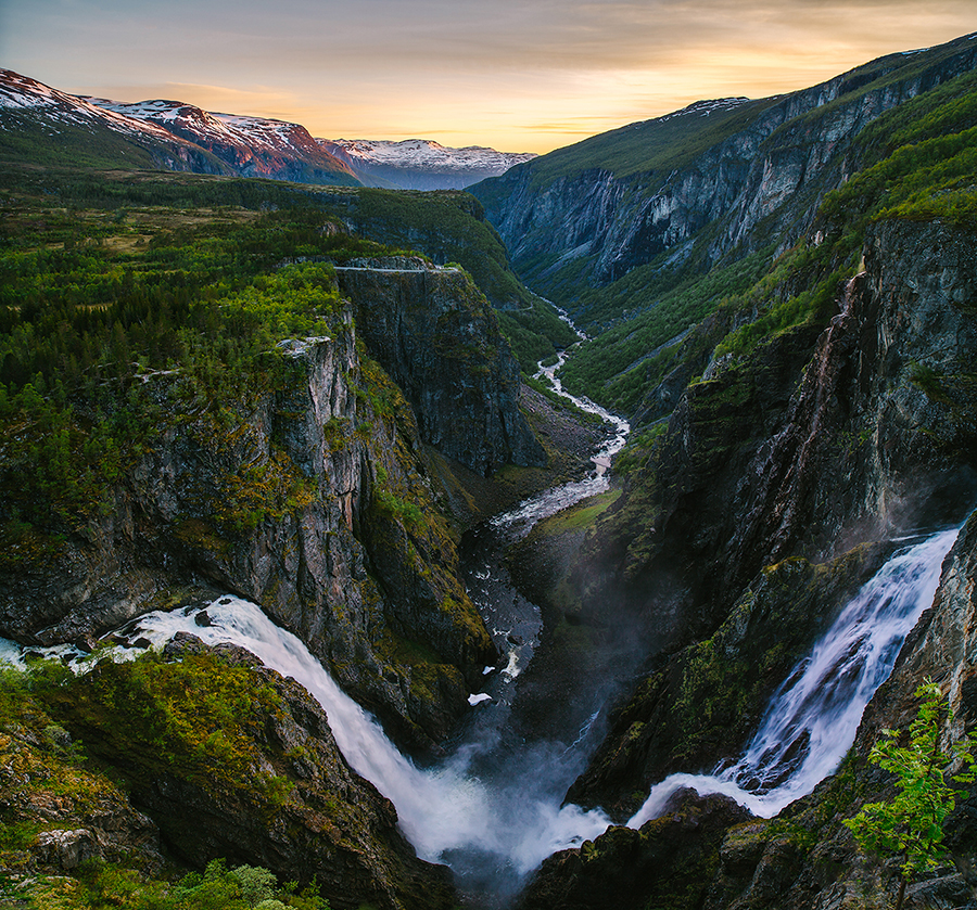 Waterfalls cutting through a green valley