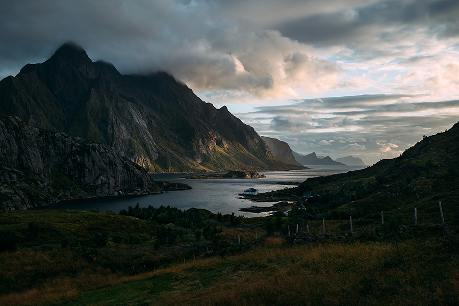 Mountain peaks beyond a valley under cloudy skies