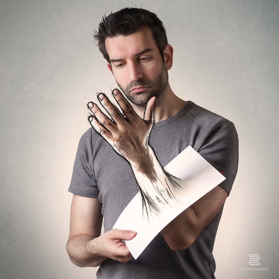 Artist examines a drawing that merges with his hand