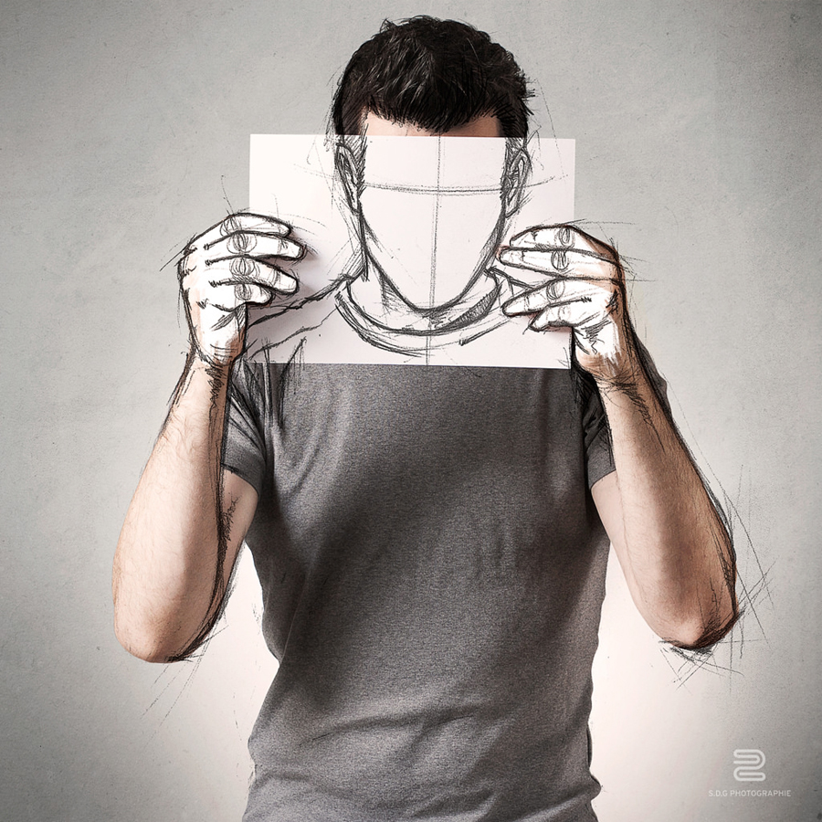 Artist holds up a sketch of a face over his portrait