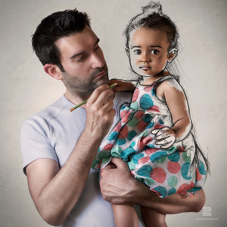 Artist holds a child beside a drawn extension of his arm