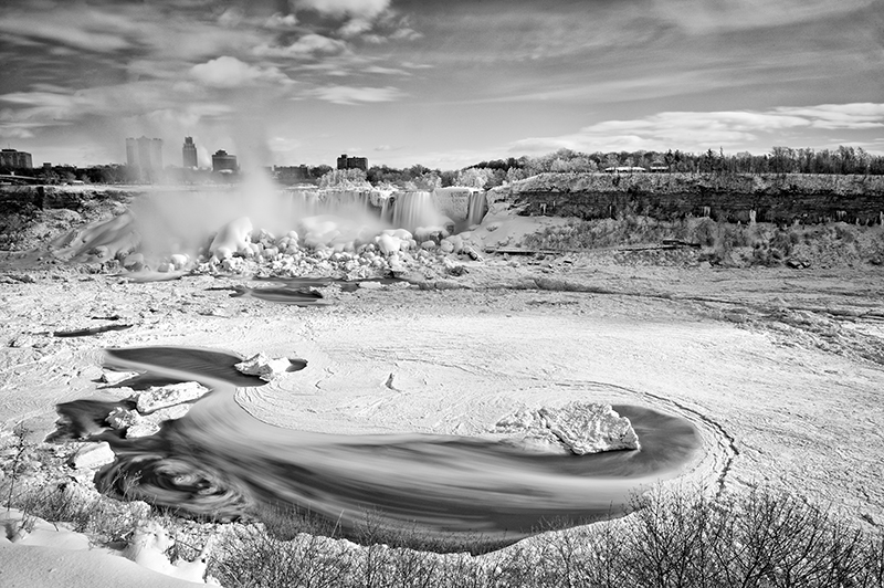 Black-and-white winter landscape beside the falls