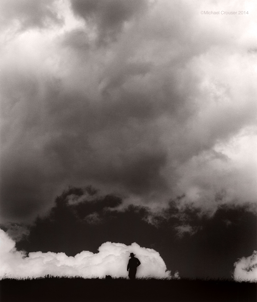 Ranch scene beneath dramatic clouds