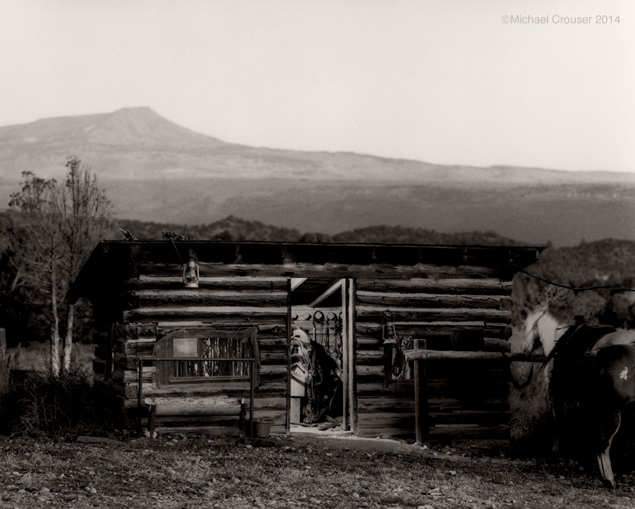 Wooden tack room in a wide ranch landscape