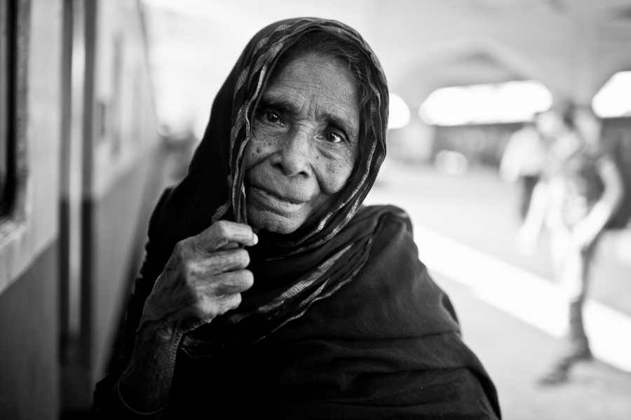Portrait of an older woman at a railway station