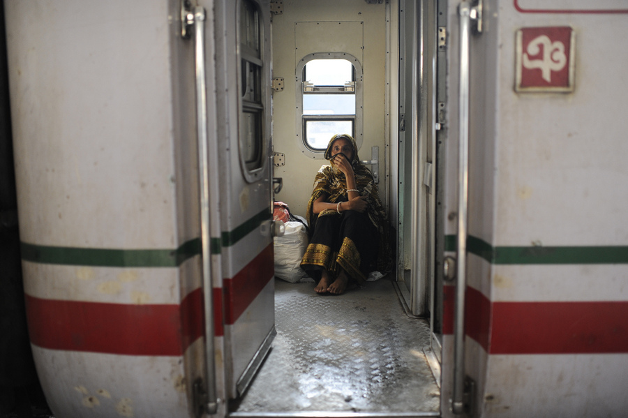 Person sitting in a train doorway