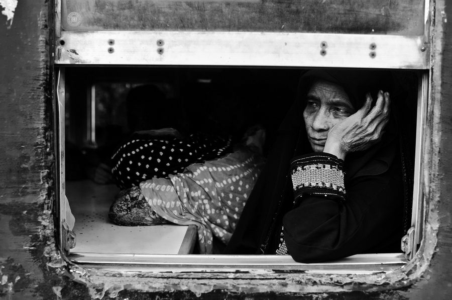 Passengers leaning from a train compartment