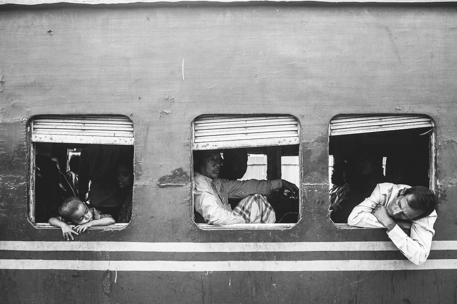 Passengers leaning from carriage windows