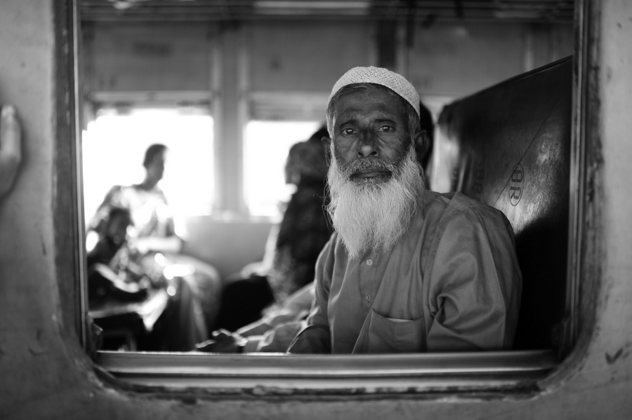 Older man looking out of a train window