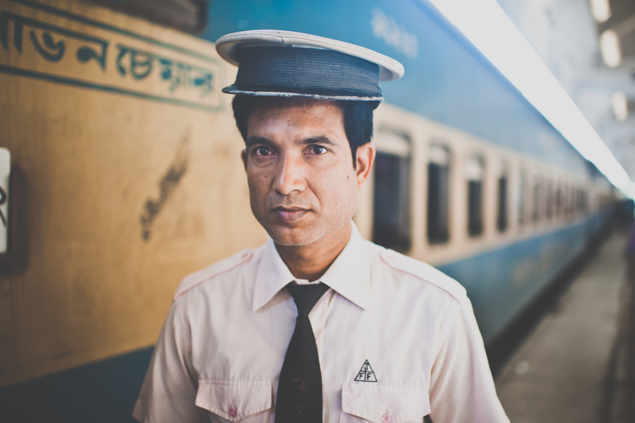 Railway employee standing beside a train