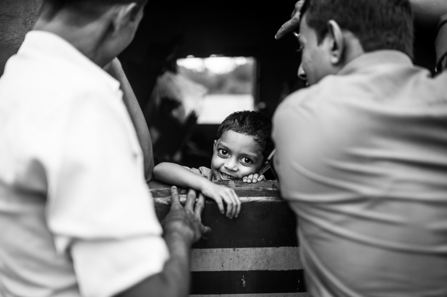 Child seen between passengers on a train