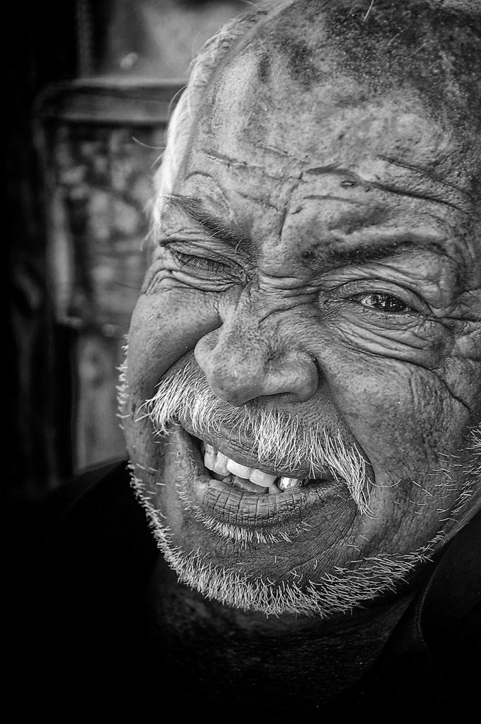 Black-and-white portrait of an older man smiling