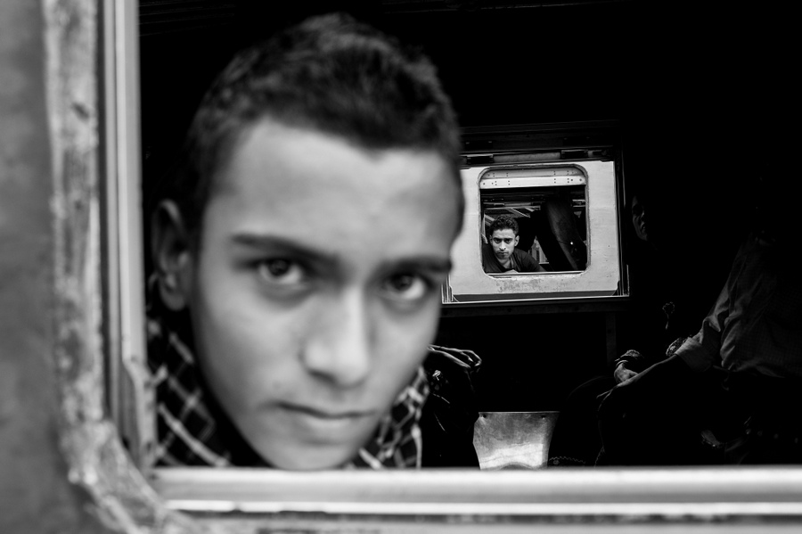 Young person looking out of a train window