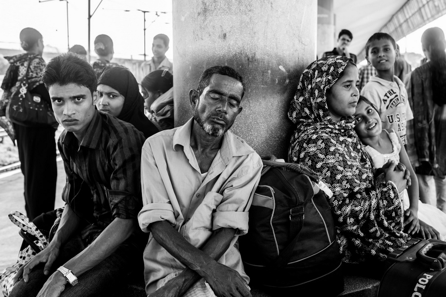 People waiting together at a railway station