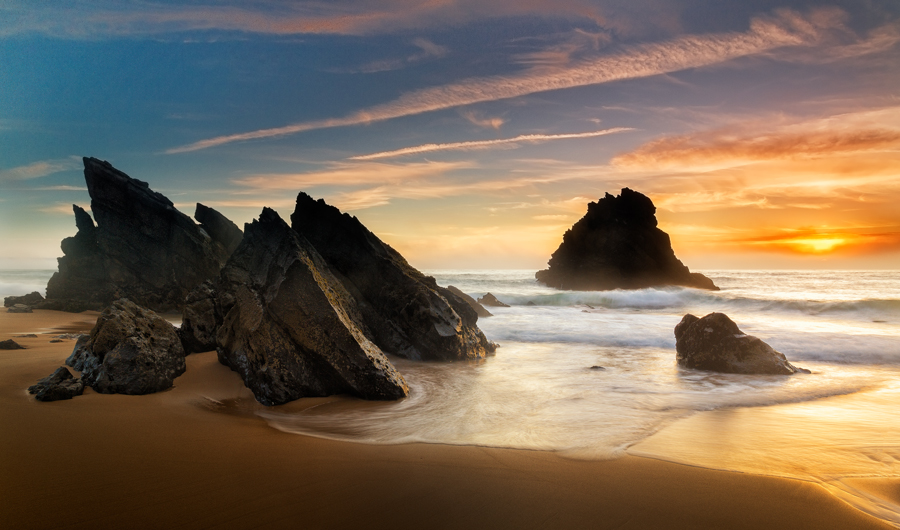 Sea stacks on a beach at sunset