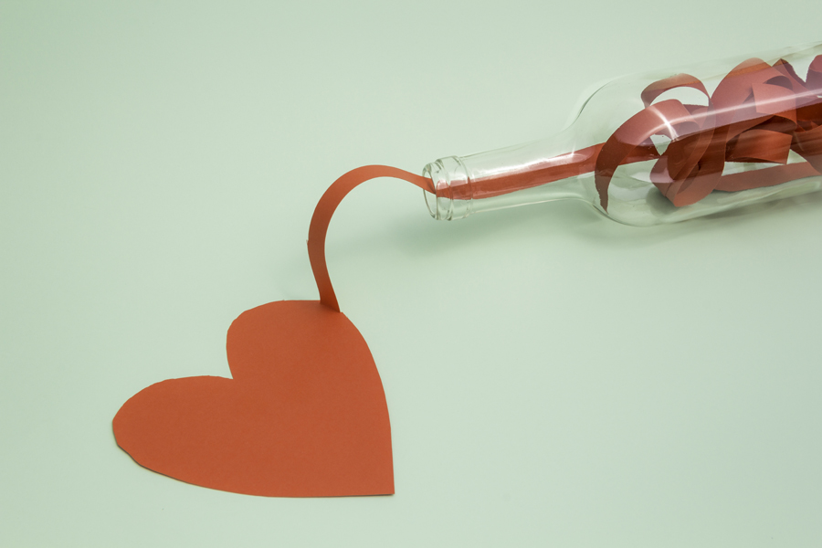 Heart-shaped paper cutout beneath a key