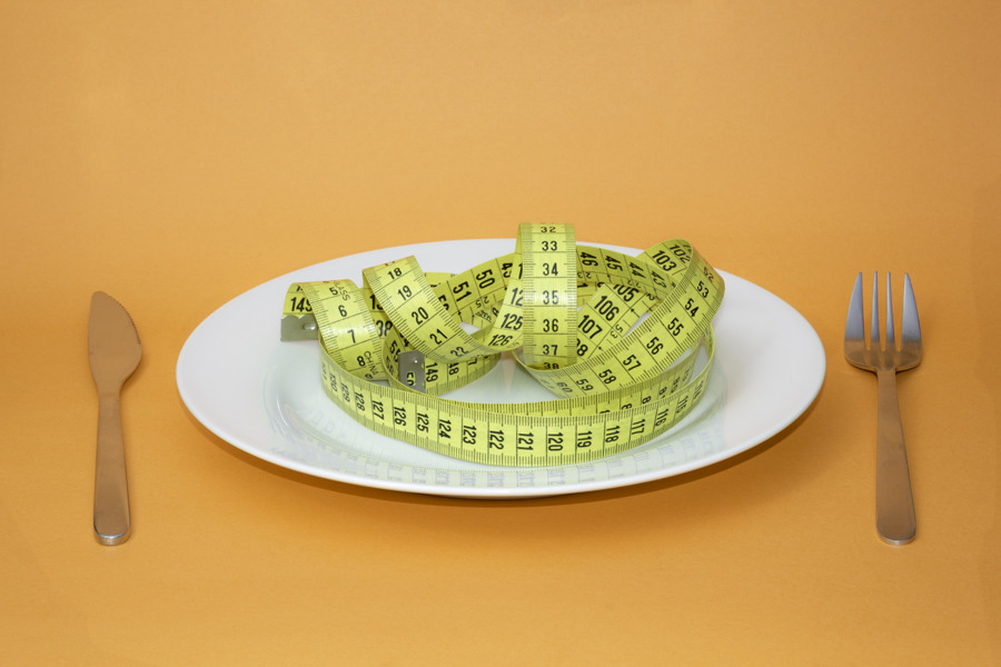 Measuring tape folded on a plate like pasta