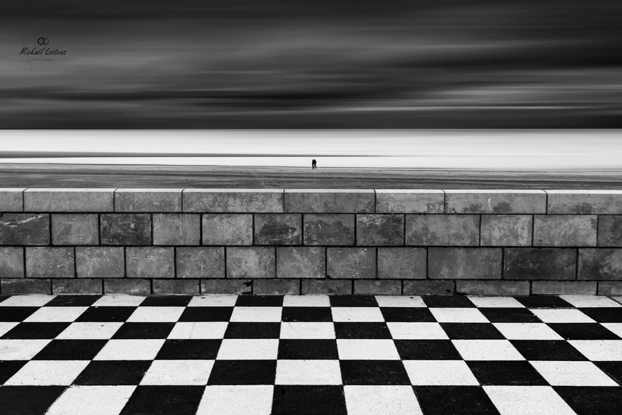 Black-and-white checkerboard tiles and stone wall