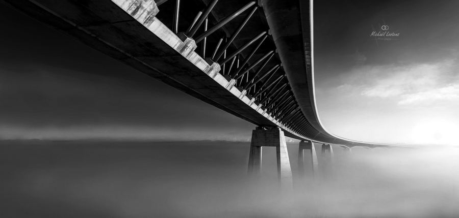 View beneath a bridge over still water