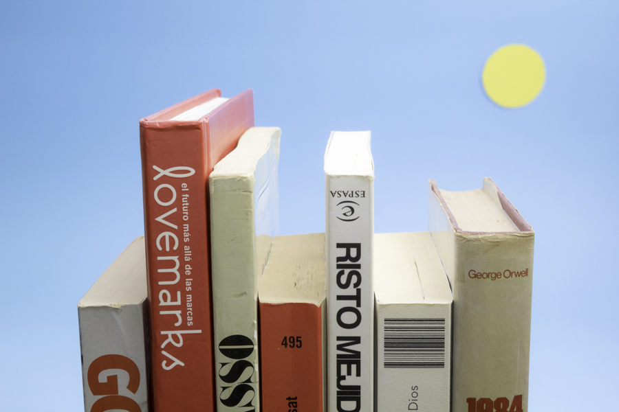 Books turned into a stylized skyline under a sun