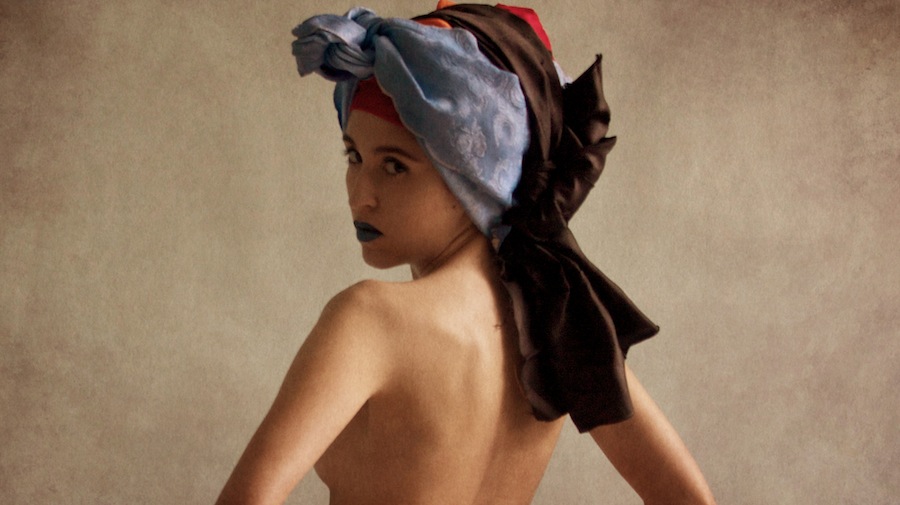 Woman looking back with a patterned scarf