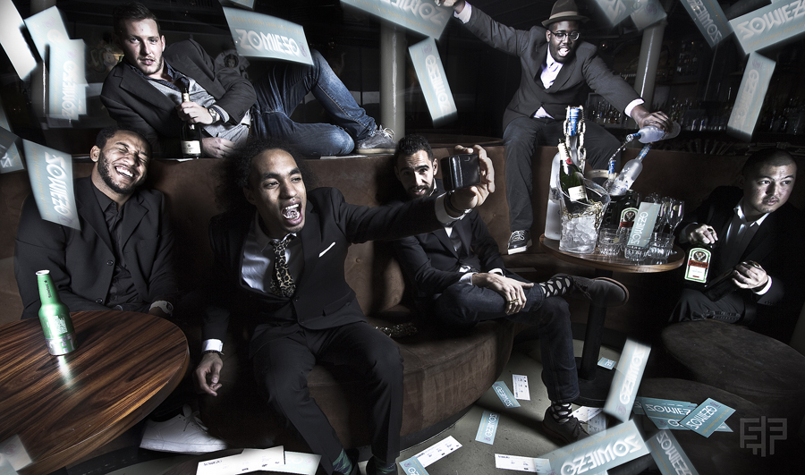 Group portrait with scattered objects suspended overhead