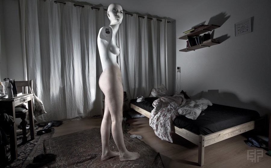 Surreal black-and-white portrait in a room with a floating figure