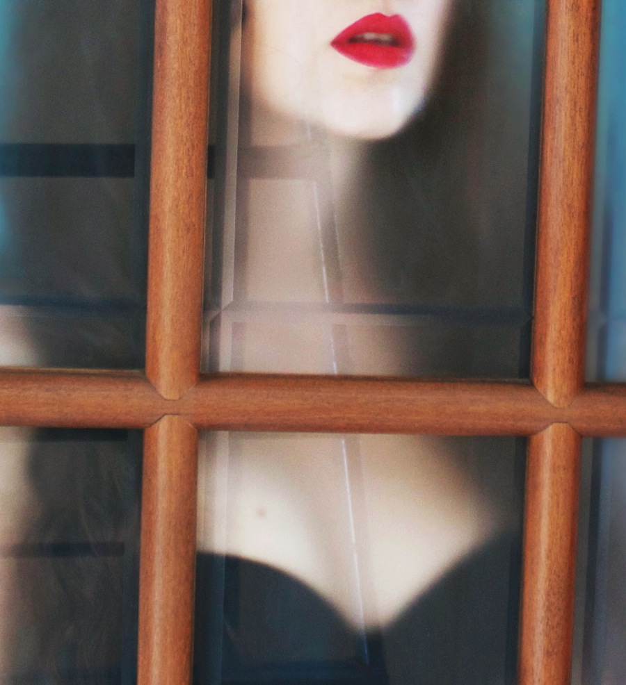 Portrait framed by a wooden window