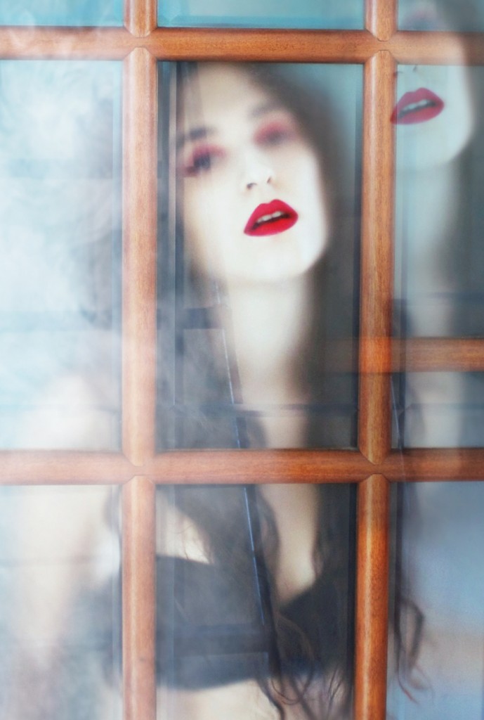 Woman seen through a blue windowpane
