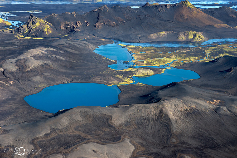 Bright blue lakes set among dark Icelandic hills