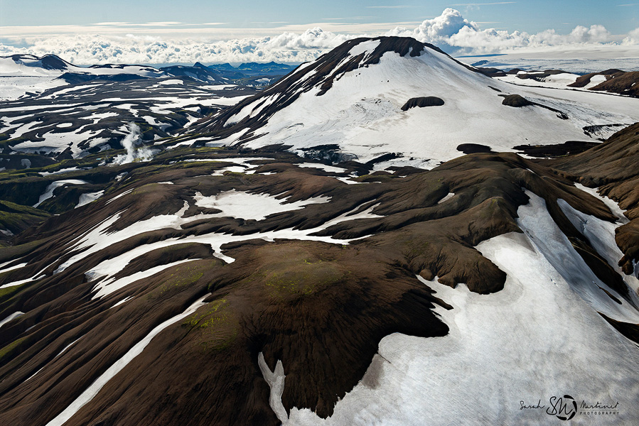 Snow-patched hills and winding streams