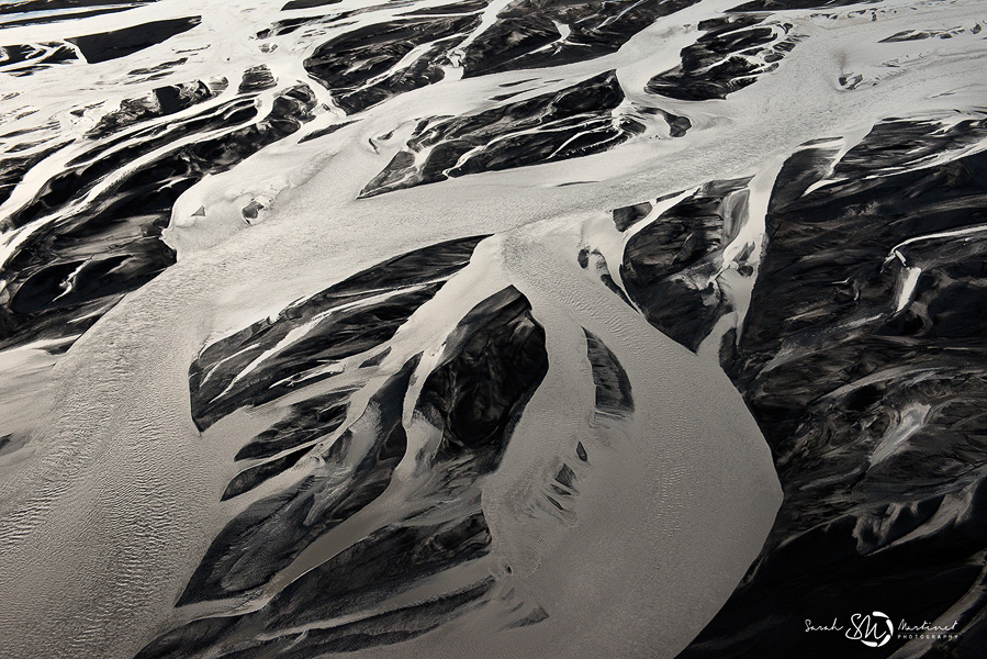 Aerial view of snow and dark volcanic ridges in Iceland