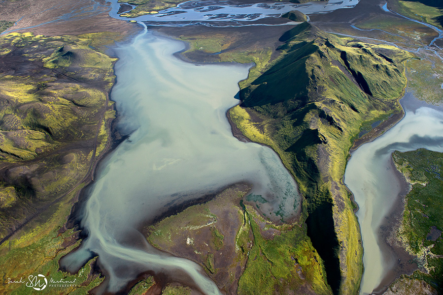 Glacial pool and green hills from above