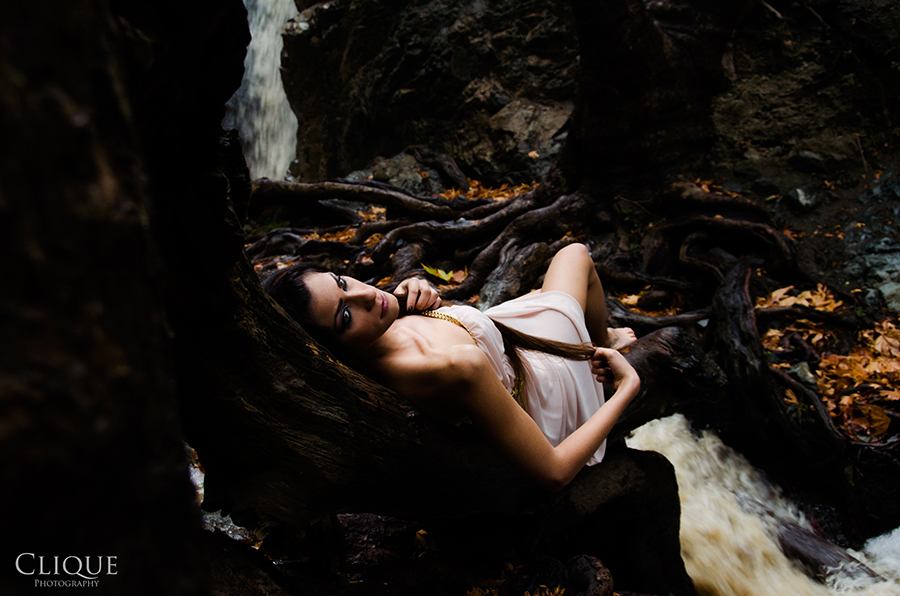 Figure reclining beside a stream