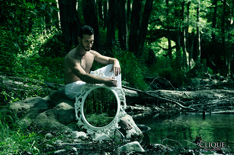 Figure seated in a green forest scene