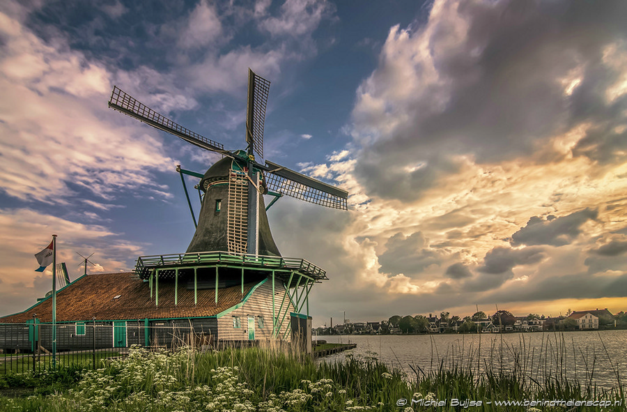 Windmill under fast-moving clouds