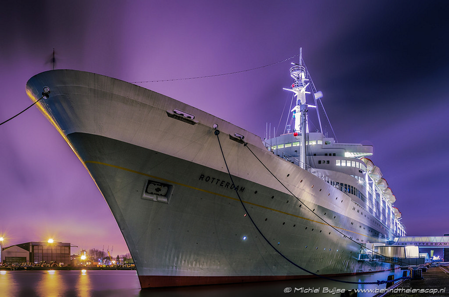 Ship moored in a city harbor at night