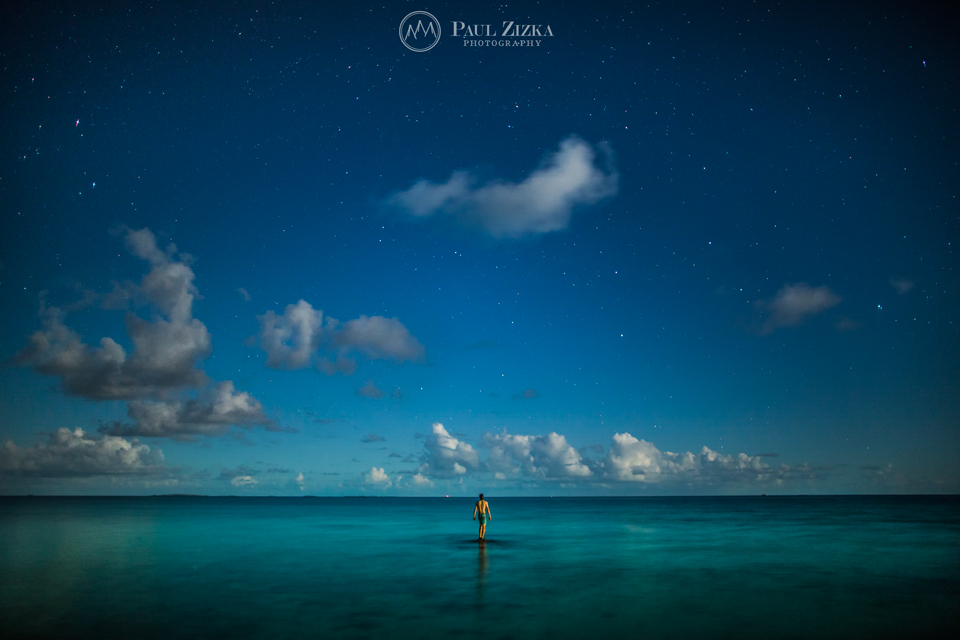 Figure standing in shallow tropical water