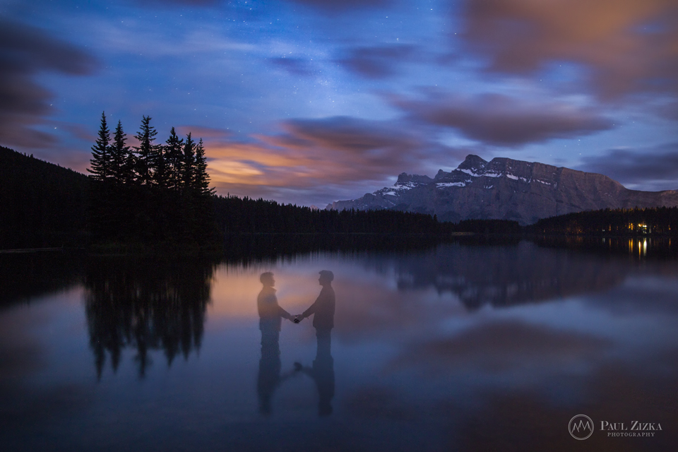 Figure standing in a lake at dusk