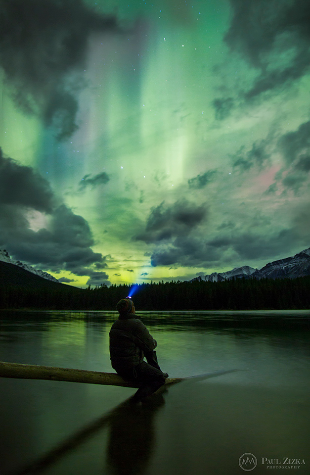 Self-portrait in water beneath northern lights