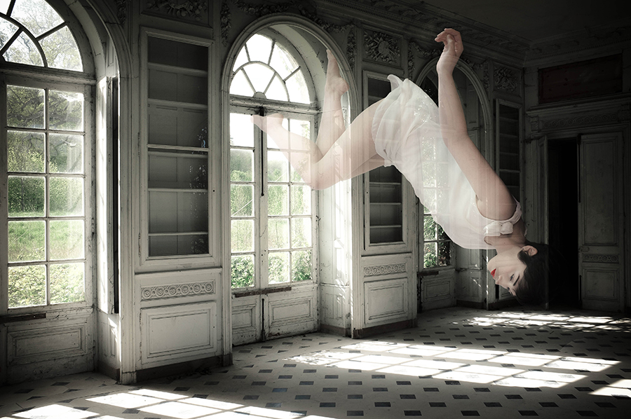 Surreal figure floating in a tiled room