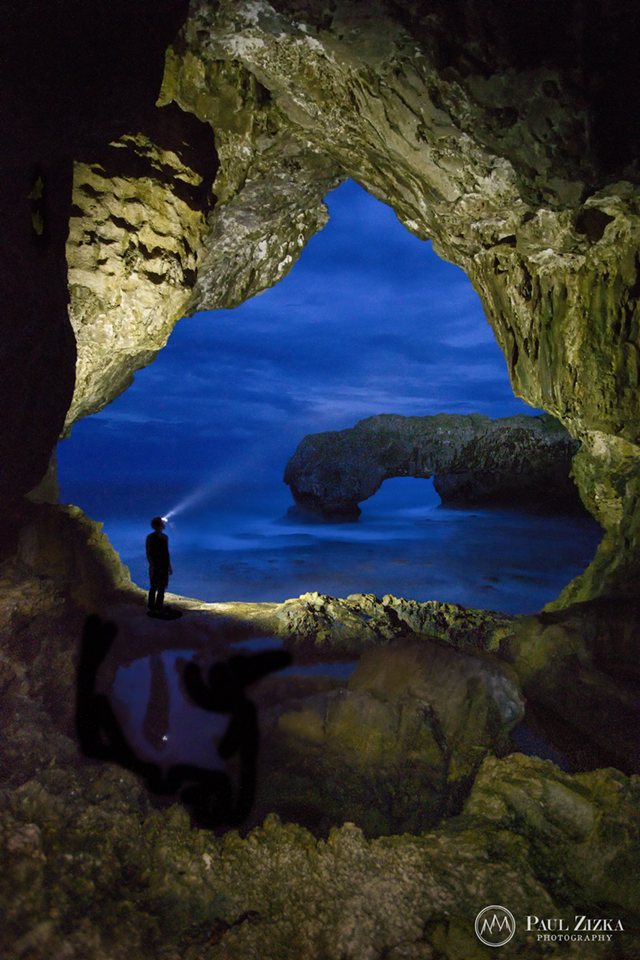 Figure framed by a sea cave