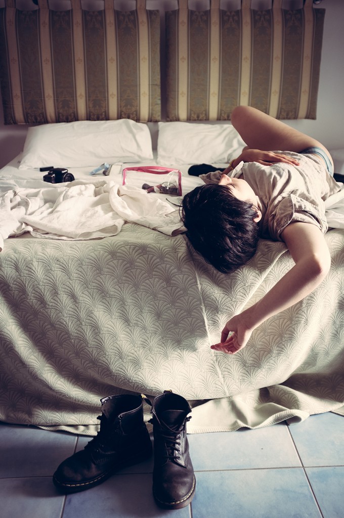 Self-portrait posed on a bed