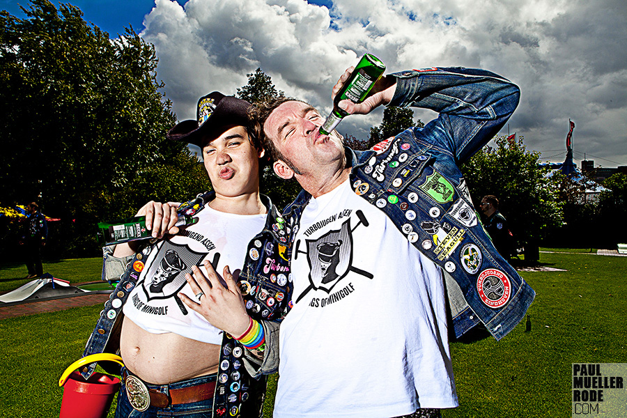 Two fans wearing denim and band shirts