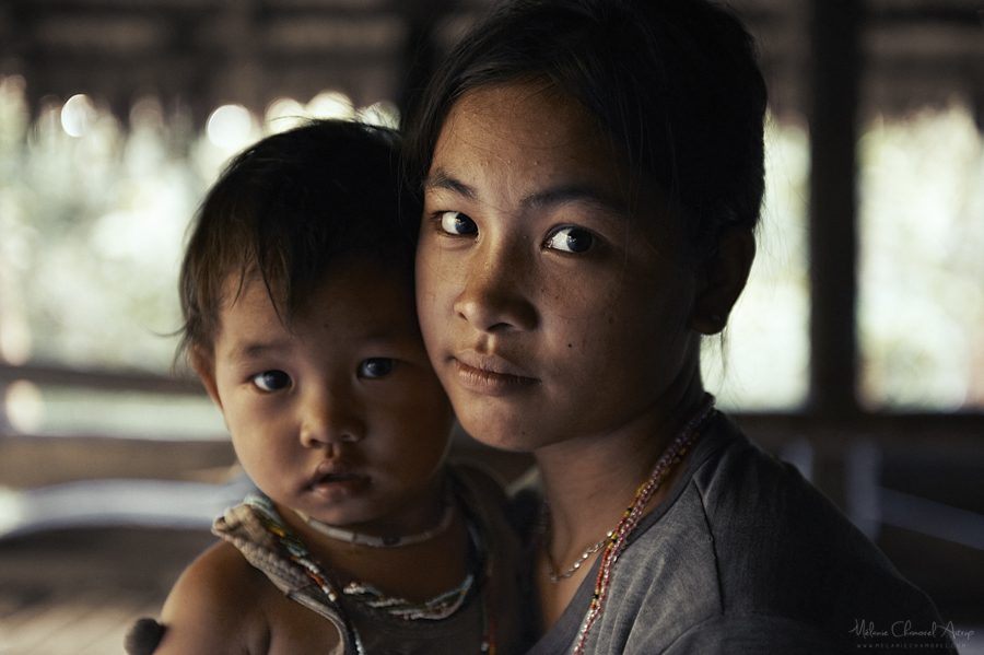 Adult and child photographed inside a home