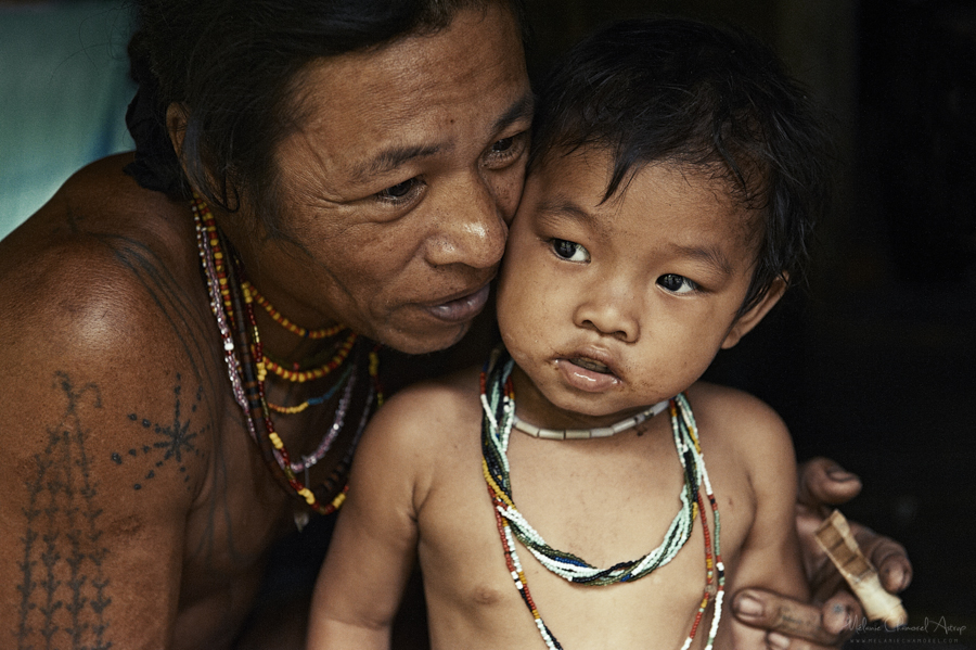 Adult holding a small child indoors