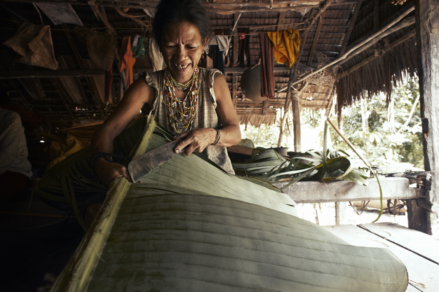 Person working on a large woven surface