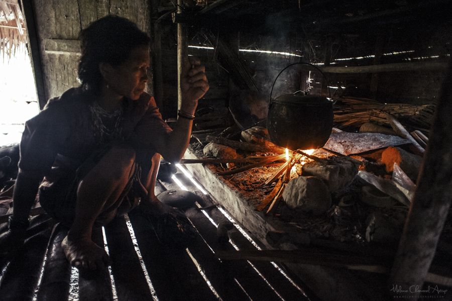 People gathered beside a fire in a home