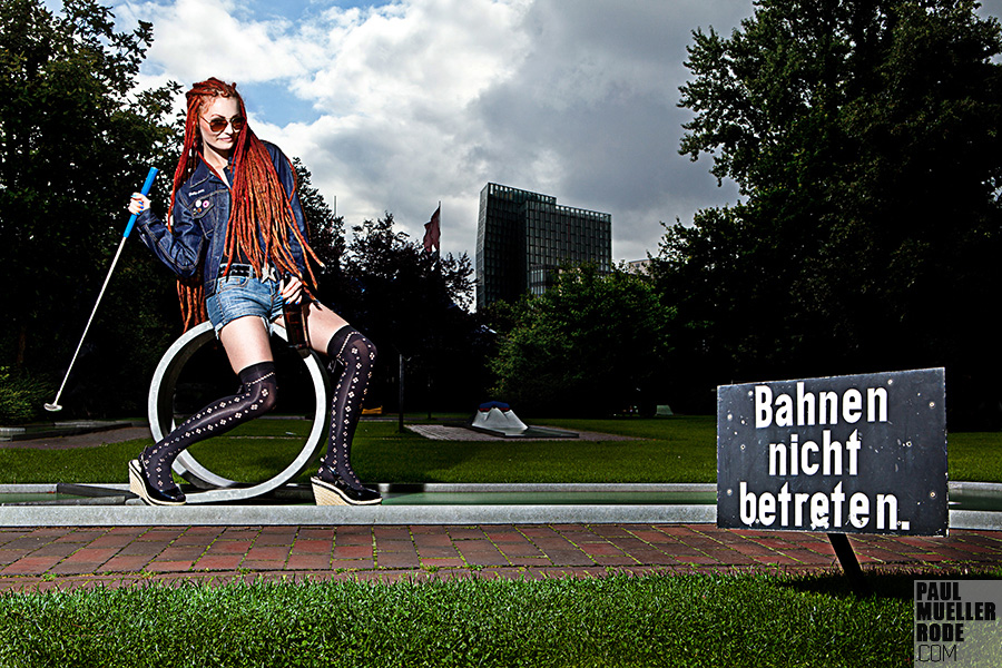 Woman sitting on a lawn in band attire