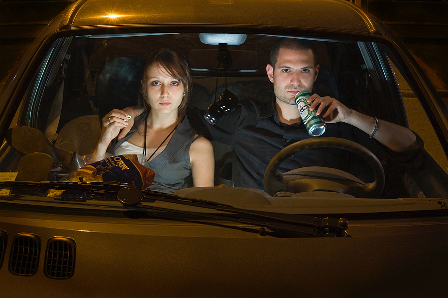 Two people sitting silently inside a car